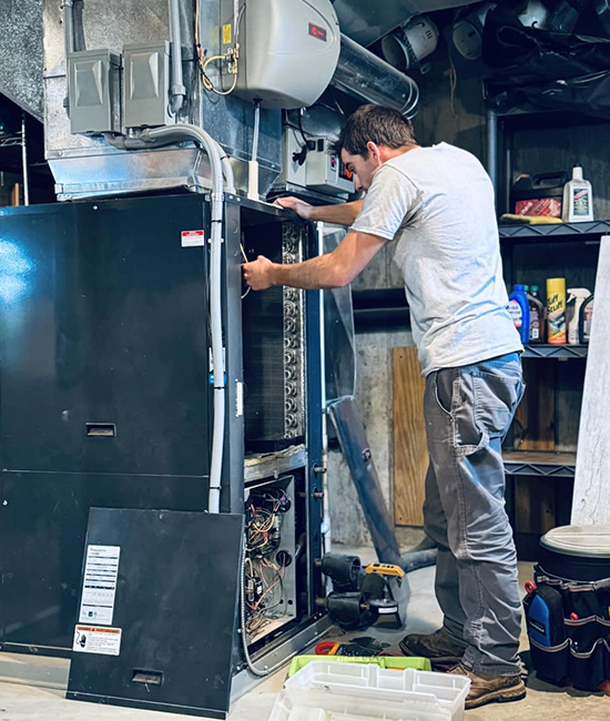 Service Technician Doing A Heating Repair